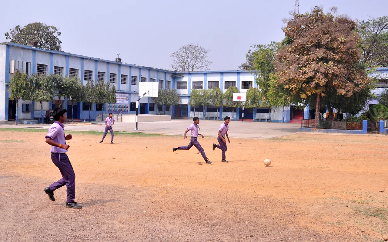 Students playing football on the Don Bosco Ramkanali campus ground